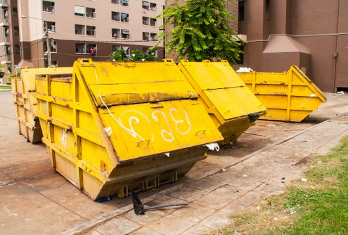 Professionals clearing garden debris with equipment